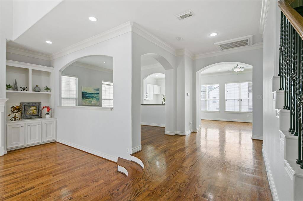Great view of the open plan throughout second level all with fresh paint, gleaming hardwood floors and arched doors.