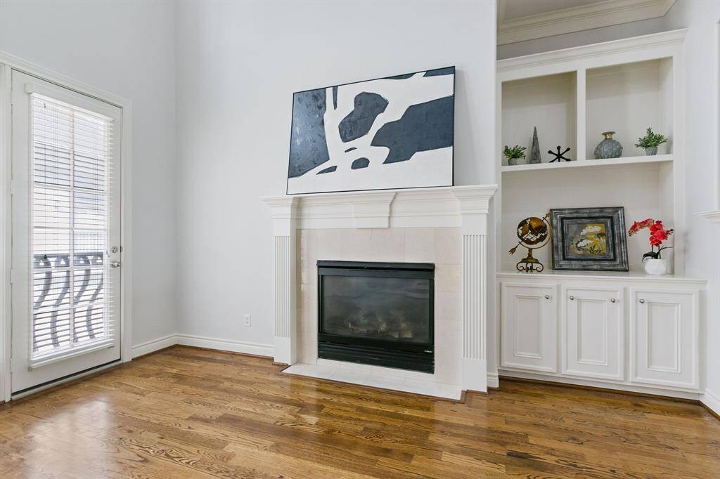 Closer view of the fireplace with mantel and great shelves with cabinets in spacious family room.