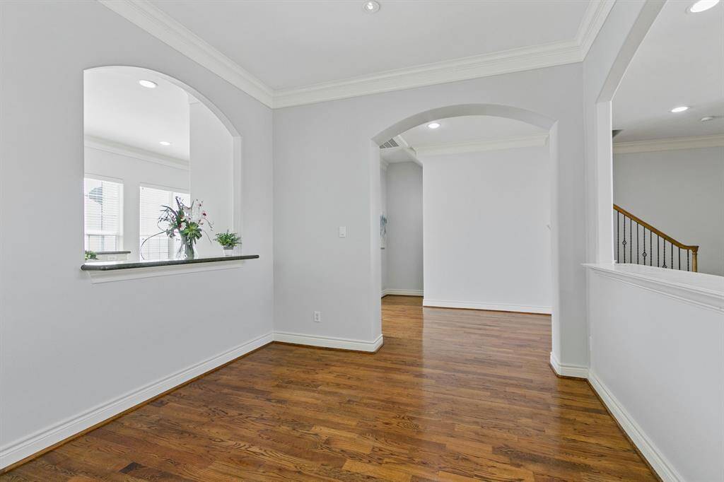 Dining area will impress your family and guests with hardwood floors and arched opening to the gourmet island kitchen