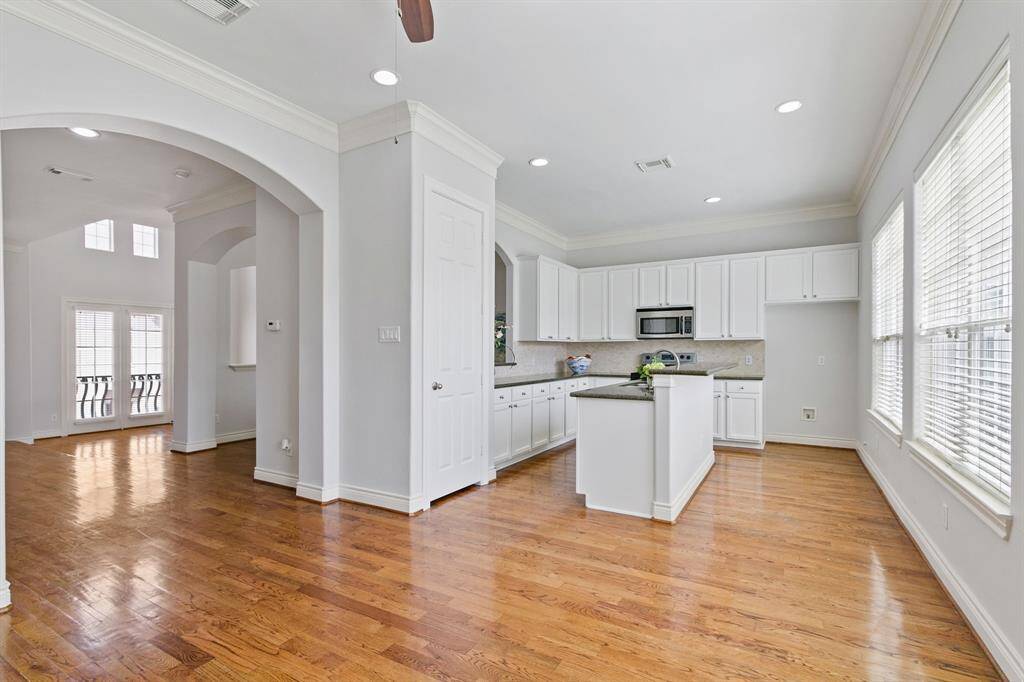 View from the huge living or breakfast area with breakfast bar and the gourmet island kitchen, all with gleaming hardwood floors.