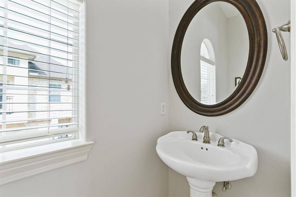 Bright half bathroom on second level.