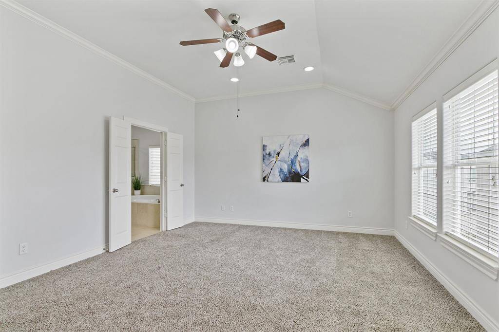 Fabulous owner's suite has high ceiling, recent carpet, ceiling fan, lots of windows and doors to full bathroom.
