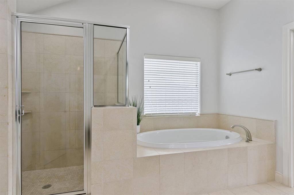 Primary bathroom is freshly painted and has separate shower and garden tub.