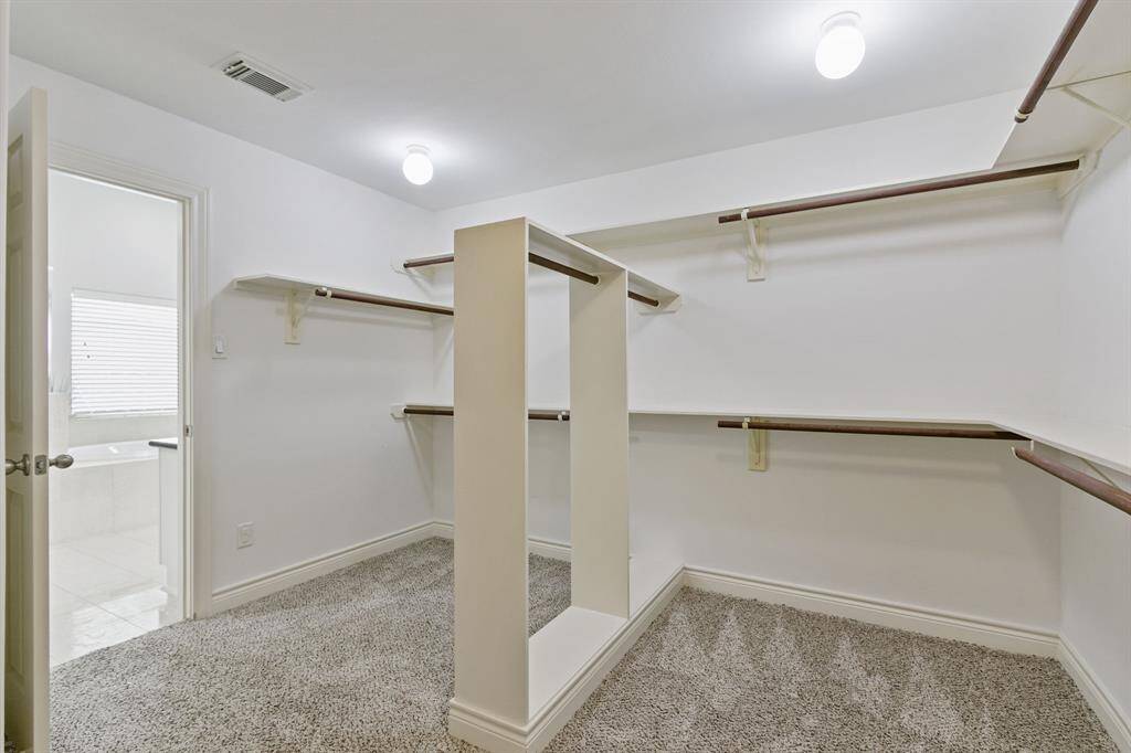 Look at this incredible walk in closet! So large it takes two pictures to show it all.