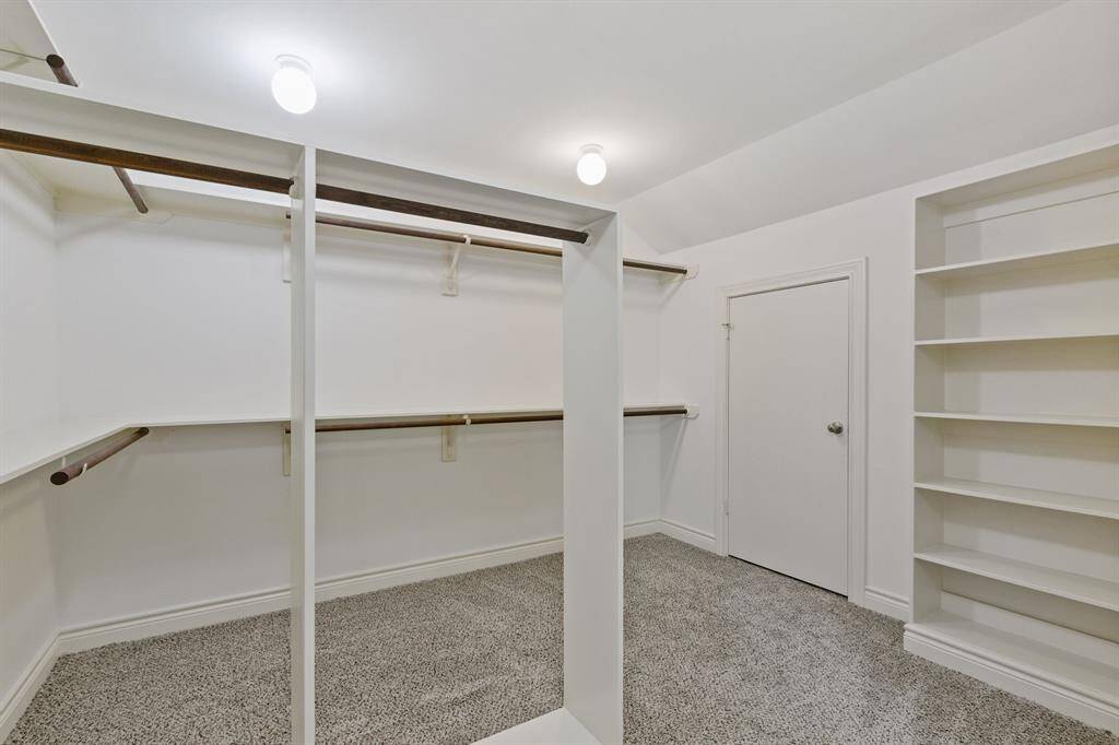 Look at this incredible walk in closet! So large it takes two pictures to show it all.