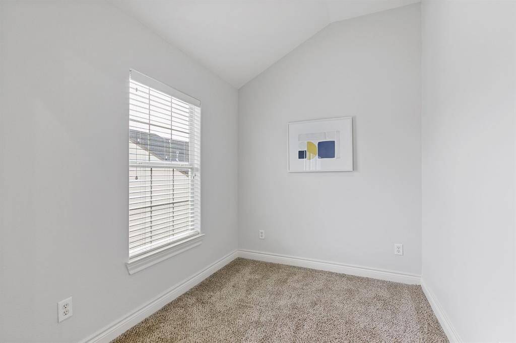 View of extra room in owner's suite perfect for an office, flex room or nursery has fresh paint and recent carpet.