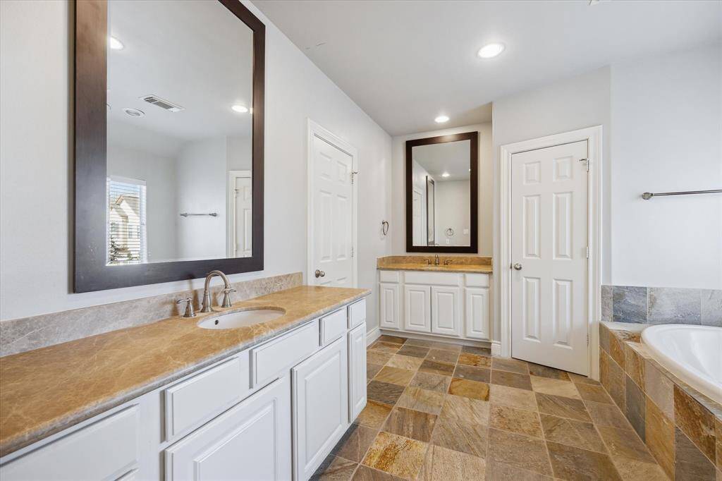 Primary en suite bath with double sinks.