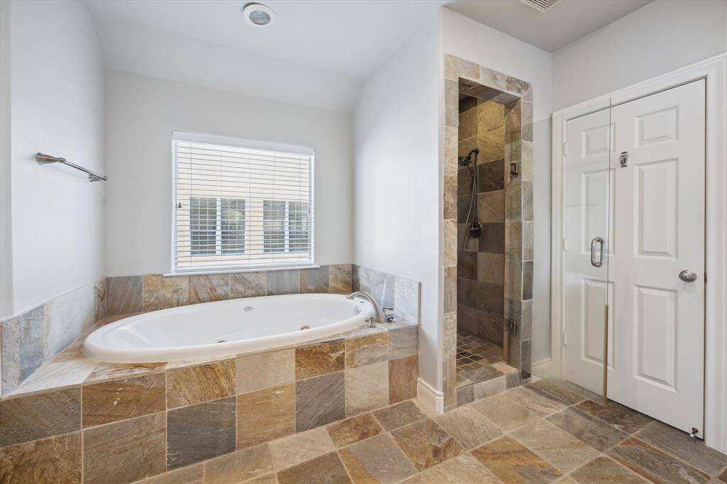 Relax in the primary bath tub and separate shower to the right.