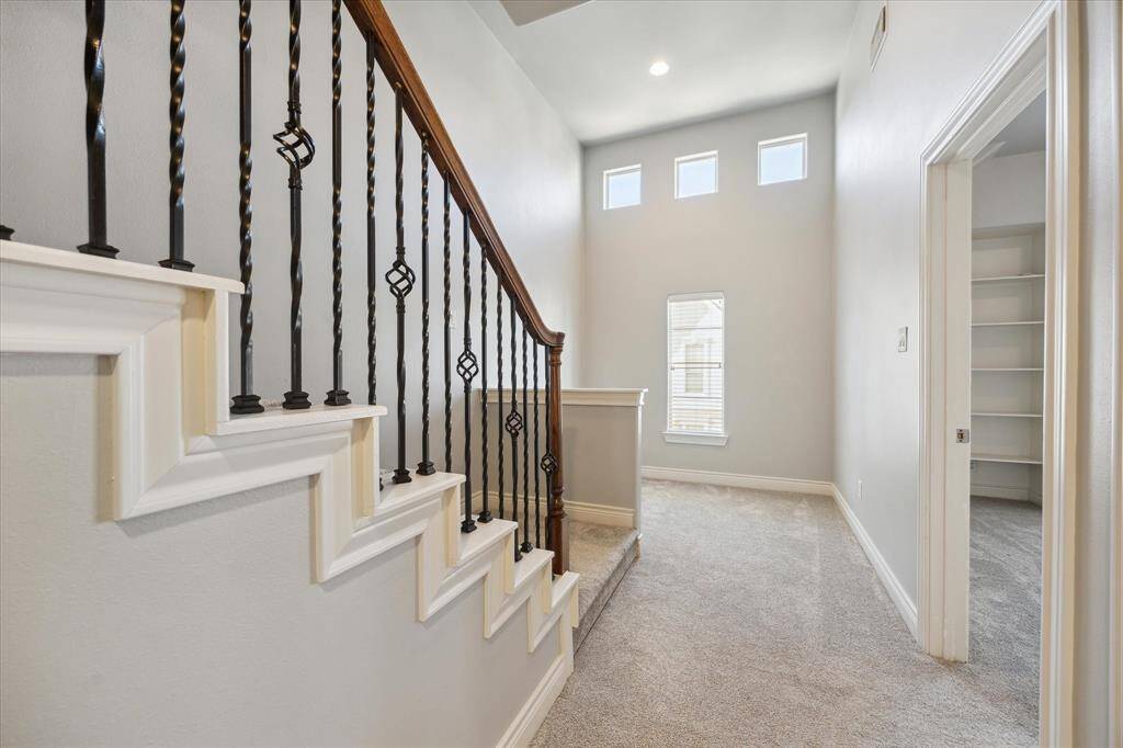 View of the second floor with stairs that go up to the third floor. Great little nook that could be versatile for your needs- reading nook, toy zone, homework area, office, or fitness area.
