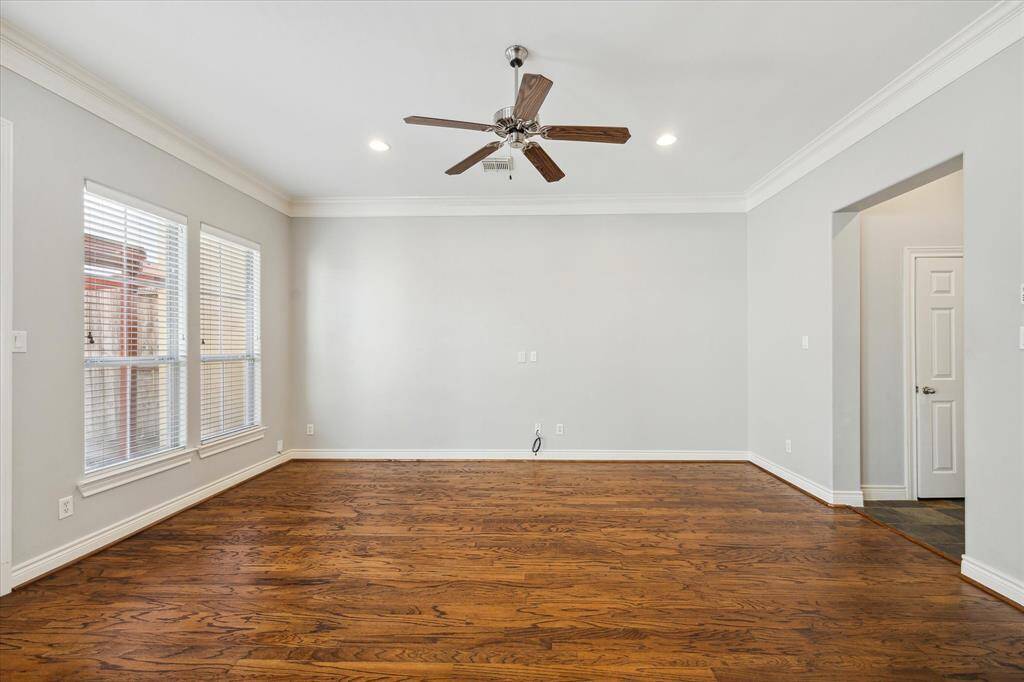 Elegant hardwood flooring complemented by tasteful, soothing wall tones in this spacious living room.