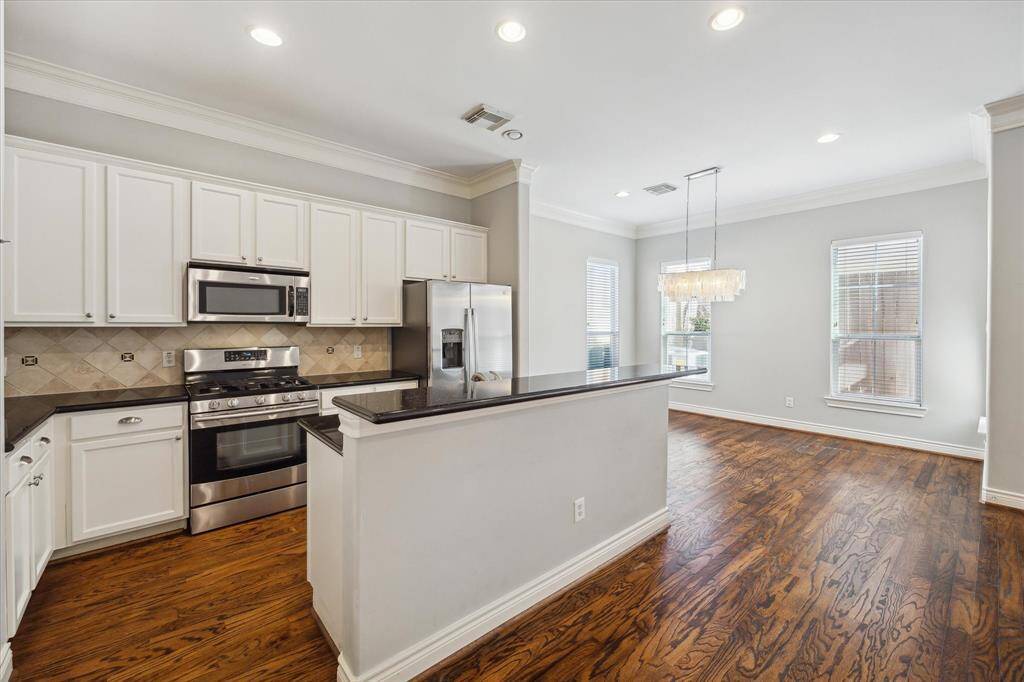 The charming kitchen is outfitted with a new refrigerator, dishwasher, disposal and faucet. Perfect for casual dining, the inviting breakfast bar is great for entertaining.