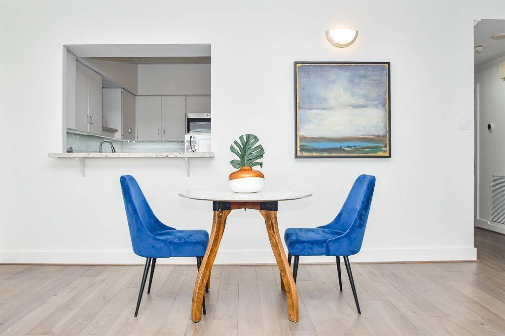 The dining area offers plenty of space for a large table or a small bistro set, as shown. This flexible space can easily adapt to your needs and style.