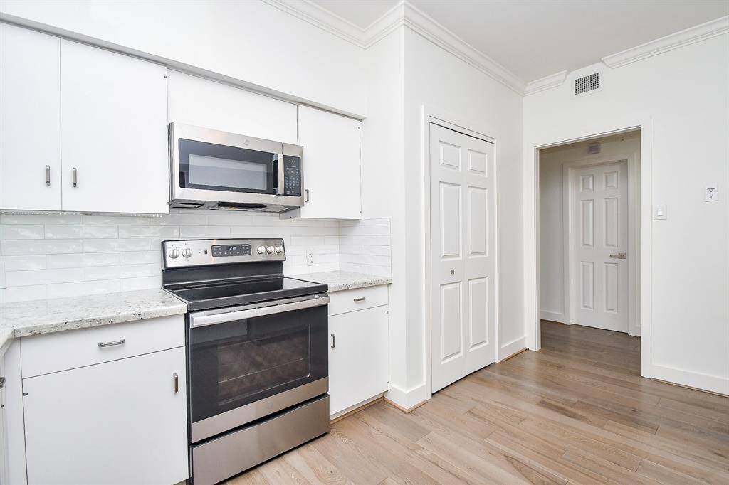 The utility closet, on the right of the stove, includes a stacked washer-dryer combo that stays with the unit.