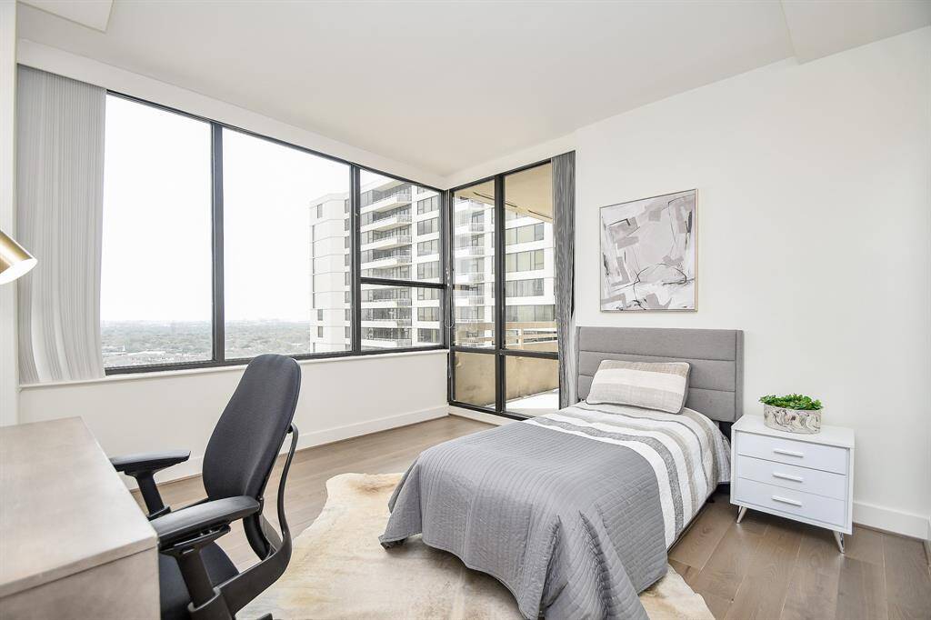 This second bedroom features hardwood floors and large windows with city views. Well-sized and multifunctional, it’s perfect for use as a guest room, home office, or any space you need.