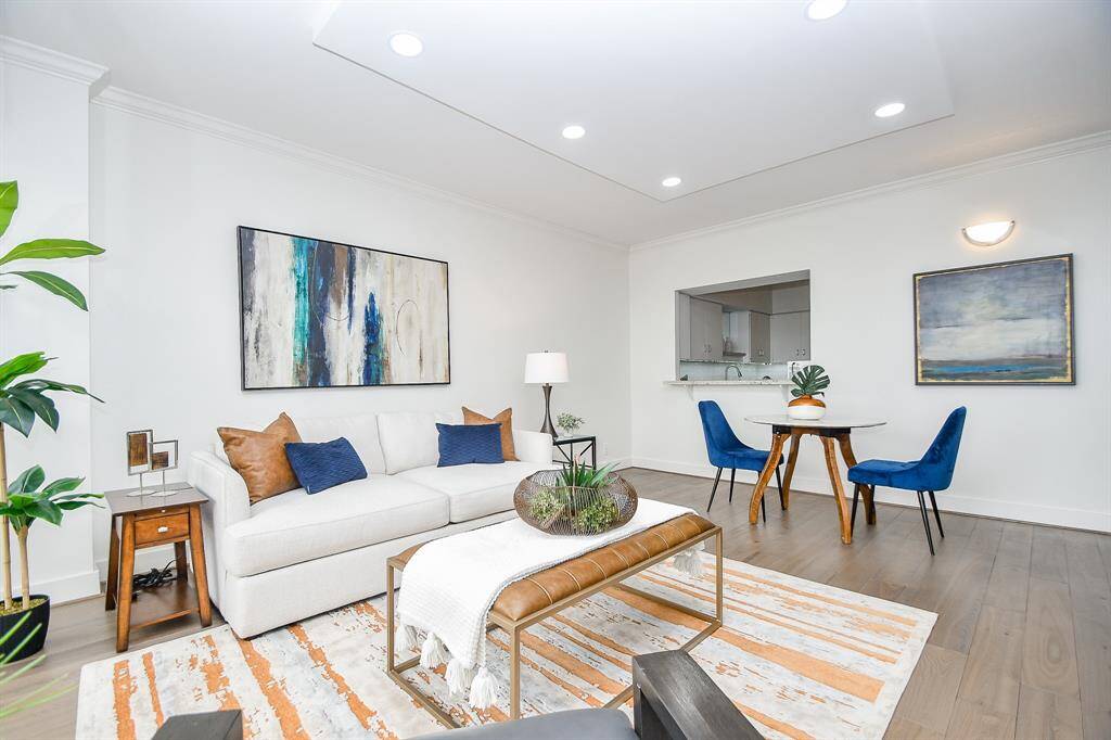 This second view of the living and dining area highlights the convenient passthrough window to the kitchen, creating an open and connected flow between spaces.