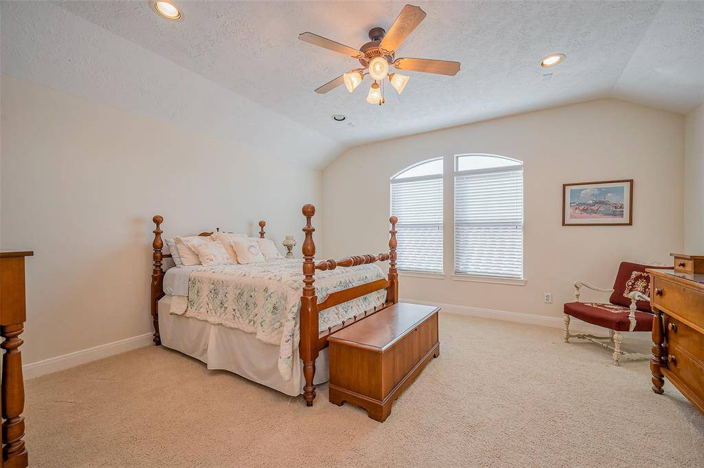 Large secondary bedroom with ensuite bathroom and high ceilings.