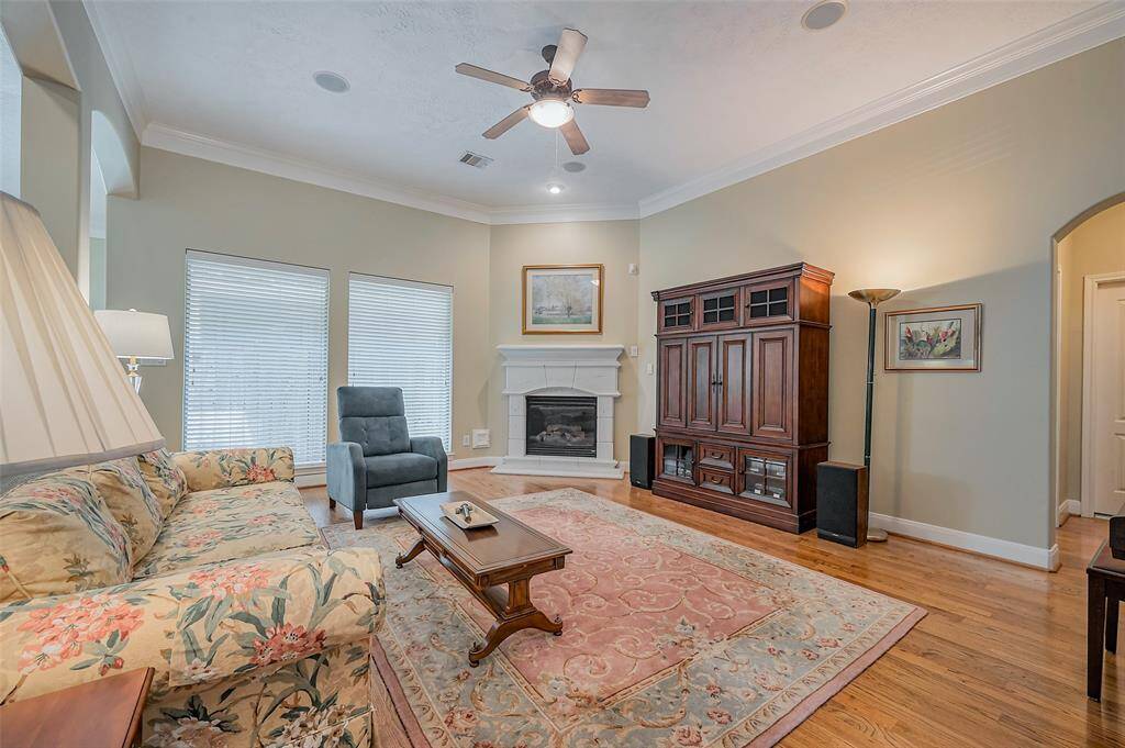 Open family room with high ceilings and gas log fireplace.