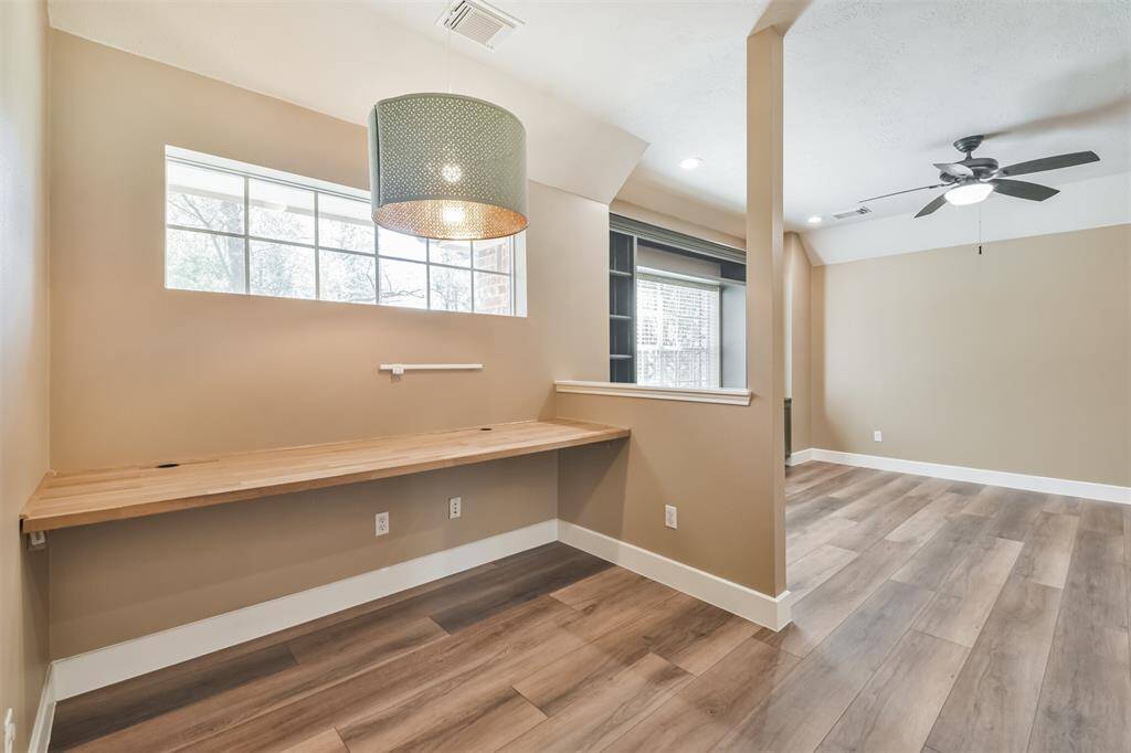 The sellers created a home office area/homework station upstairs adjacent to the gameroom. With a built in desk with cord management, your workspace looks clean and efficient. The beautiful light fixture elevates the space.