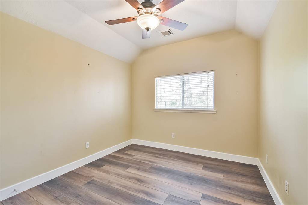 One of the 3 upstairs bedrooms with luxury vinyl plank flooring and ceiling fan.