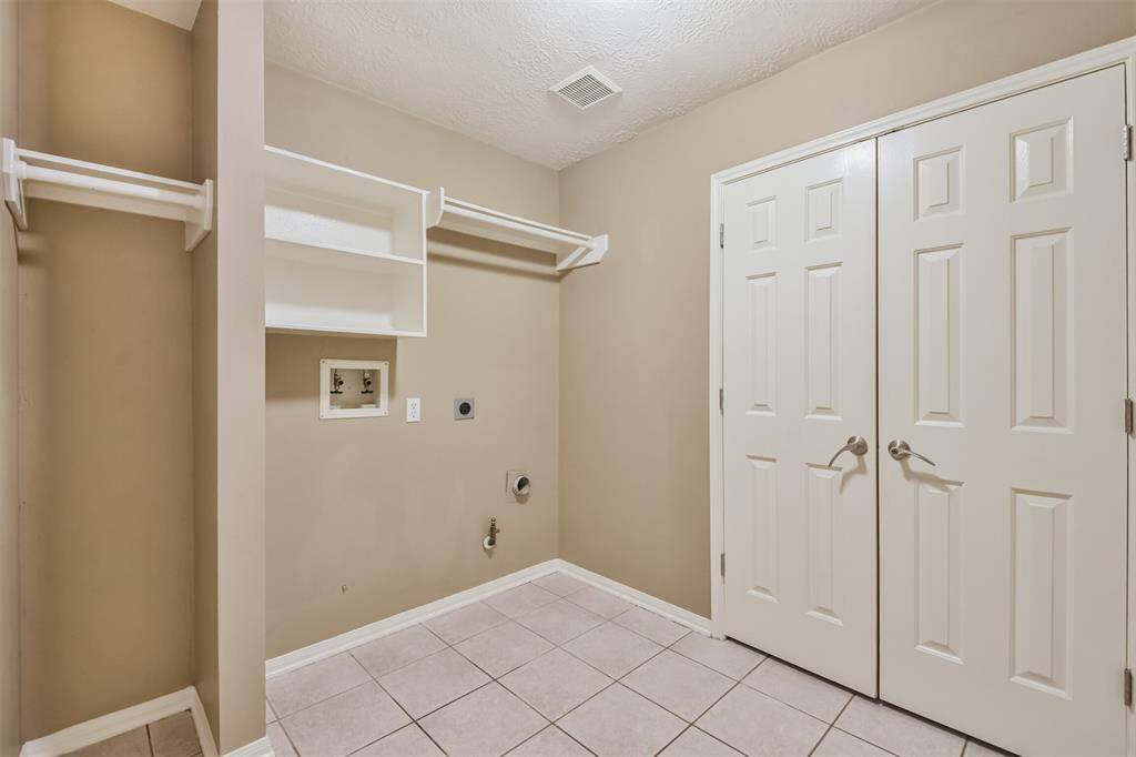 The utility room has options for gas or electric appliances and features a very large storage closet.