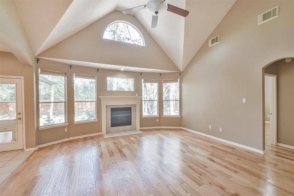 The two story living room is designed to be the heart of the home with its wood floors and wall of windows overlooking the back yard all centered around the gas fireplace with mantle. This cozy but spacious living room is perfect for family gatherings.
