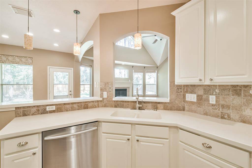 Notice the integrated double basin sink and stainless steel dishwasher.