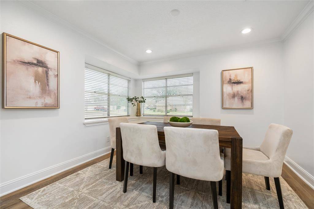 The dining area is conveniently located just off the kitchen - the corner bar by the windows is ideal for serving!
