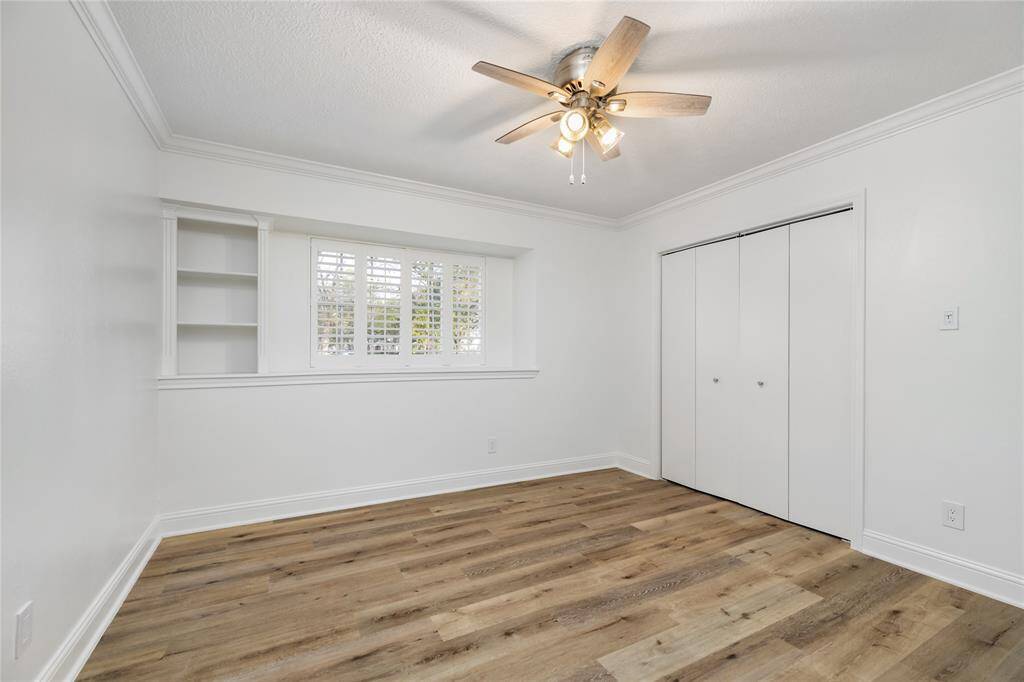 Back into the hallway, you will find this second bedroom with LVP flooring and great closet space.