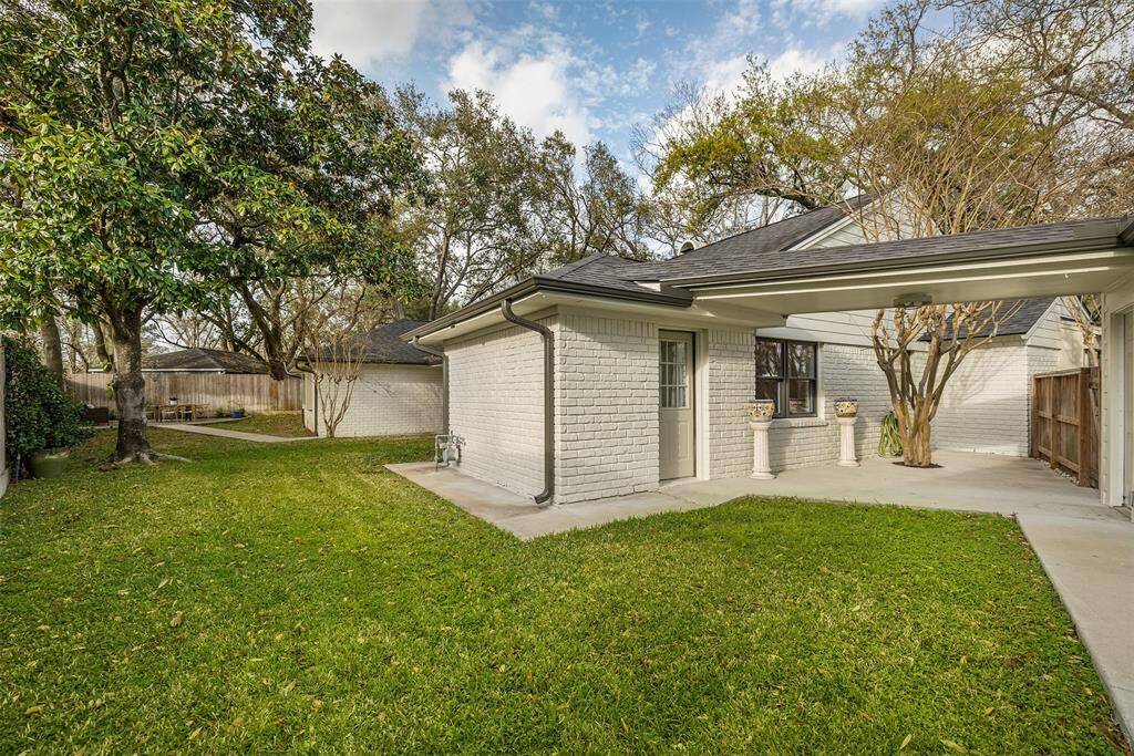 View of this sprawling backyard with so many ways to enjoy being outside.