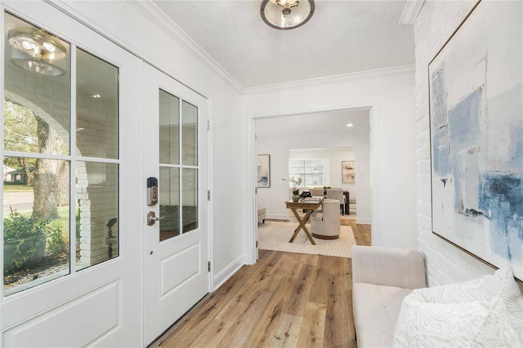 A view of the entry way inside the inviting front porch and double front doors. You will love the natural colored LVP flooring throughout. No carpet!