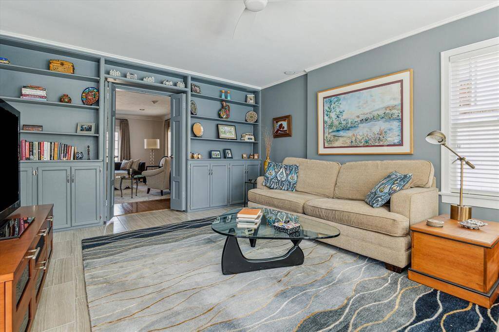 Another view of the den/family room with bookshelves and storage cabinets.