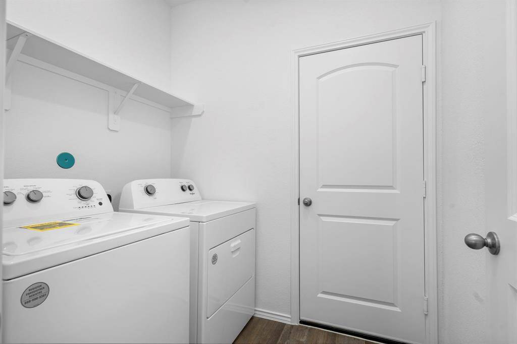 A spacious laundry room with built-in shelving, a brand-new full-size washer and dryer included!