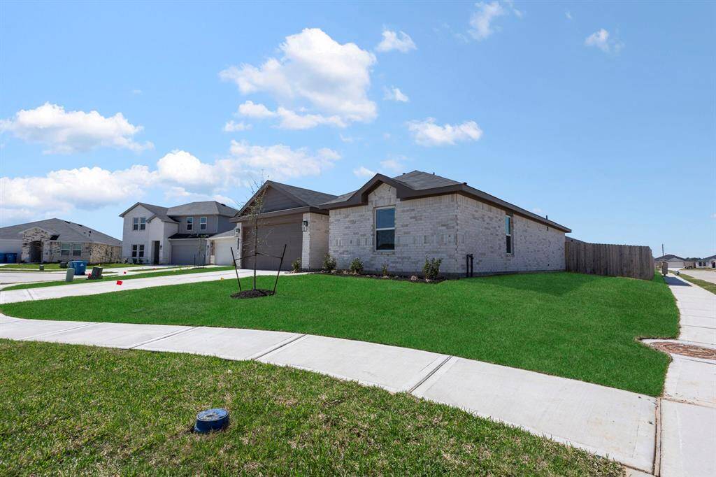 This stunning home sits on a spacious cul-de-sac lot, featuring a beautifully maintained lawn, modern brick exterior, and an extended driveway leading to a two-car garage.