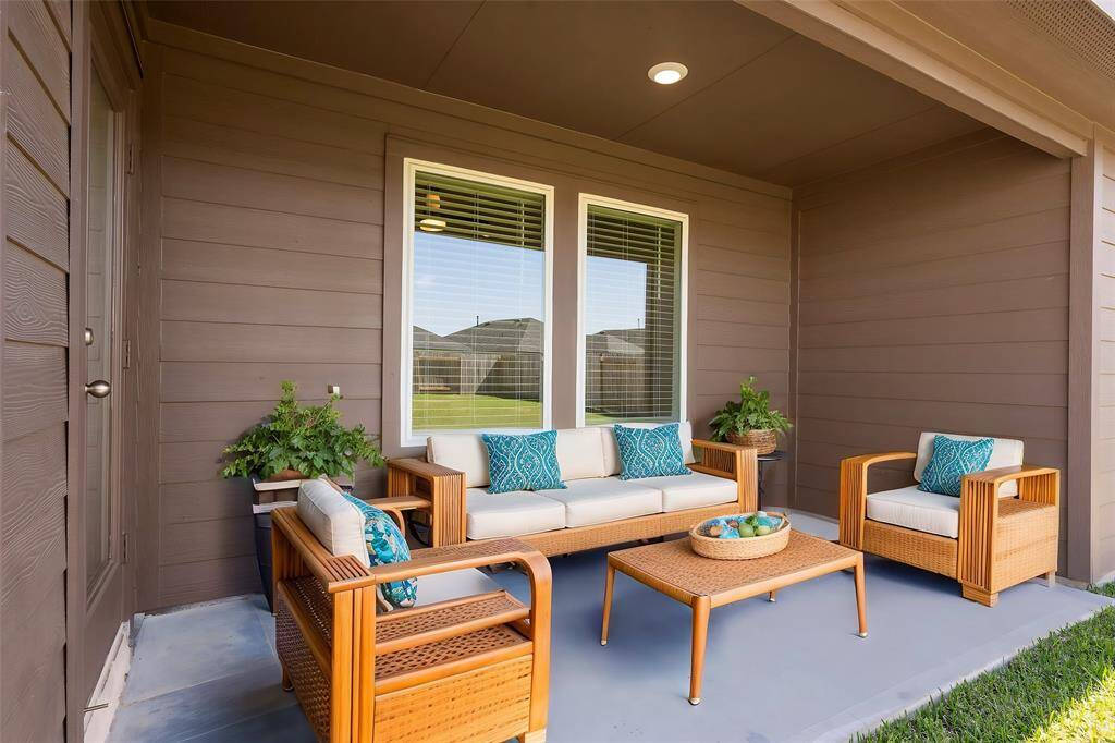 Enjoy year-round outdoor living on this cozy covered patio, perfect for morning coffee or evening relaxation. **Photo is Virtually Staged to show how it would look like**