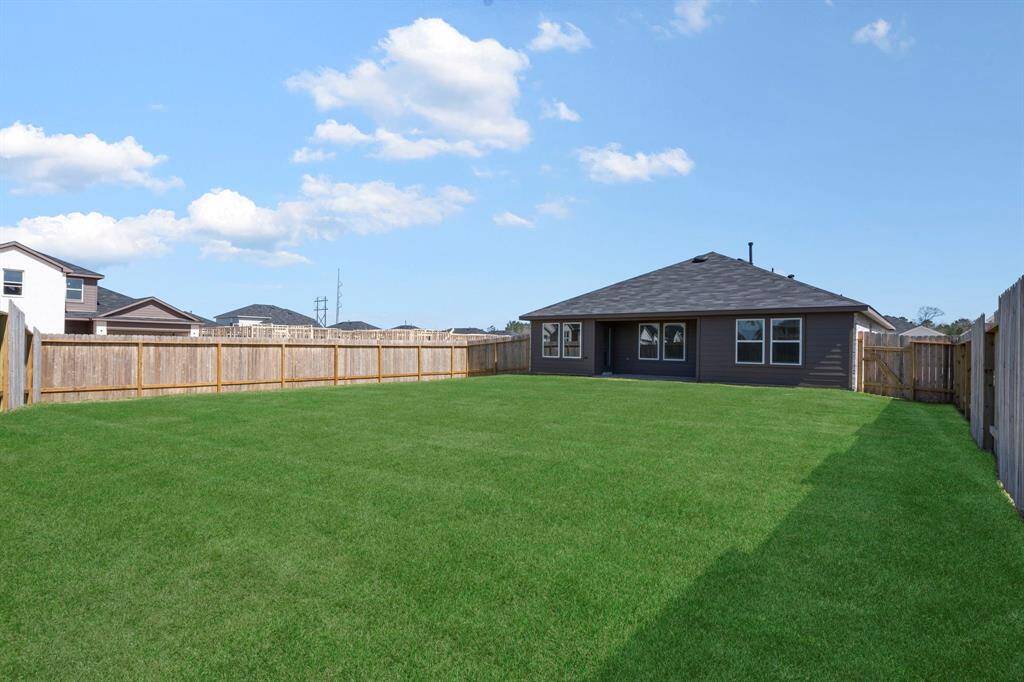 The large backyard is perfect for those who love outdoor living, with ample space for kids, pets, or simply enjoying the fresh air.  Sprinkler system!
