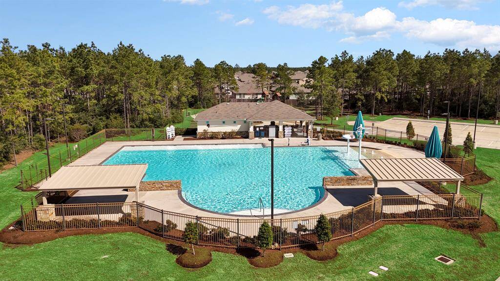 Relax and unwind at the gorgeous community pool, featuring lounge areas, shaded seating, and a serene natural backdrop.