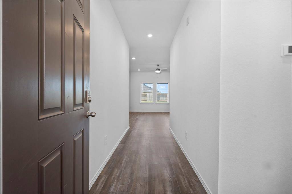 Step inside to a bright and airy entryway with high ceilings and stylish wood-like vinyl plank flooring that flows effortlessly into the main living areas.