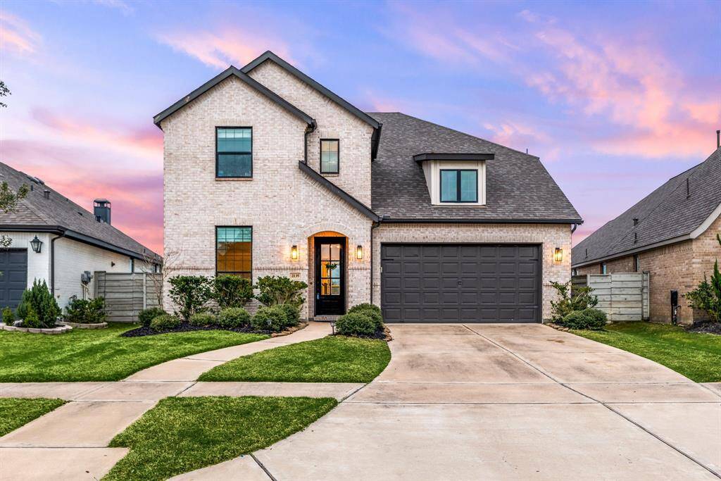 Welcome home to 2135 Blackhawk Ridge Ln. located on a quiet street in Pomona and zoned to Alvin ISD! This stunning home has lovely curb appeal, a well-manicured lawn, beautiful landscaping, stone/brick elevation, dark stained front door with glass detailing, covered front porch, traditional style, dark stained shutters, beautiful outdoor lanterns and a double wide driveway!