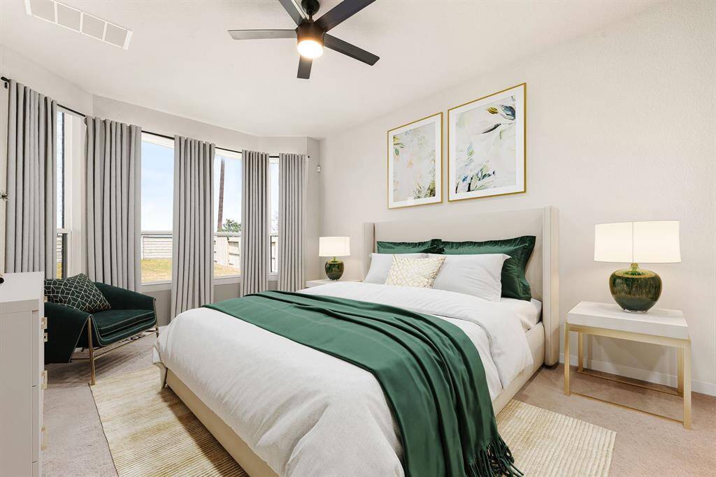 What a wonderful place to come home to, this stunning primary suite greets you with plush carpet, a warm custom paint, high ceiling, ceiling fan with lighting, lovely arched windows allowing in natural light brightening up this spacious primary bedroom, with extra space for a seating area. *Virtually Staged