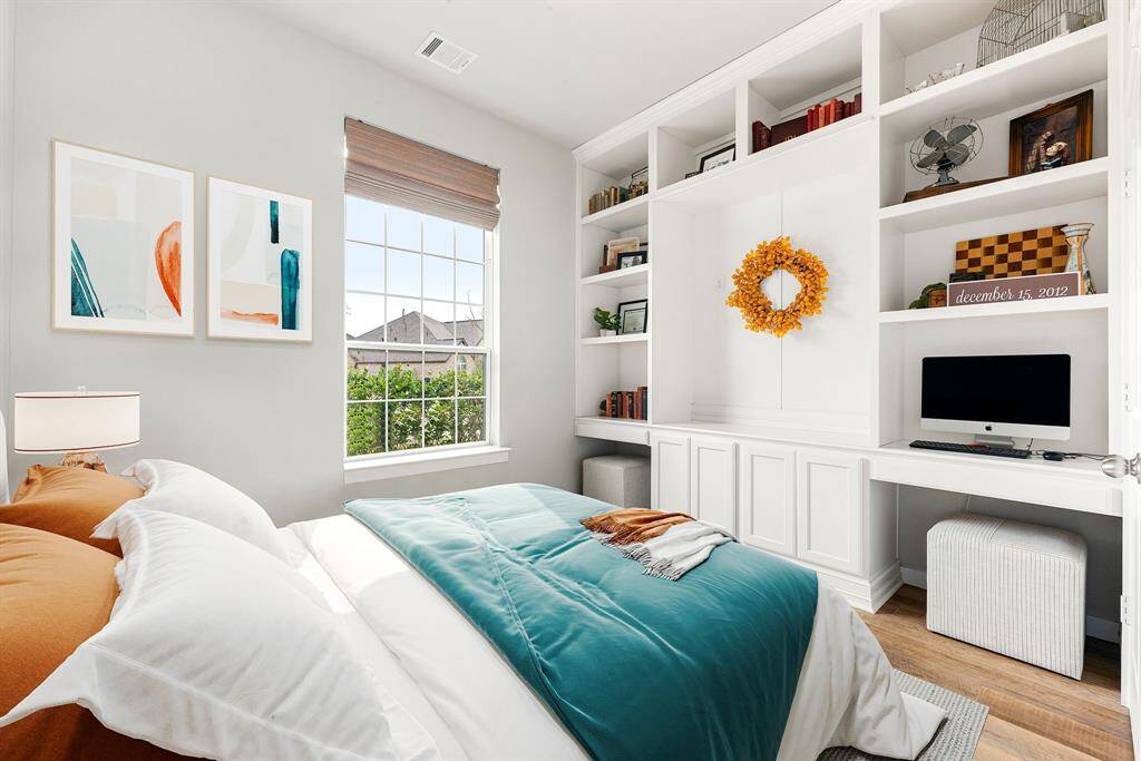 On the first floor of the home there is a second bedroom perfect to accommodate staying guests. Secondary bedroom features plush carpet, custom paint, dark stained ceiling fan with lighting and a large window with privacy blinds. *Virtually Staged