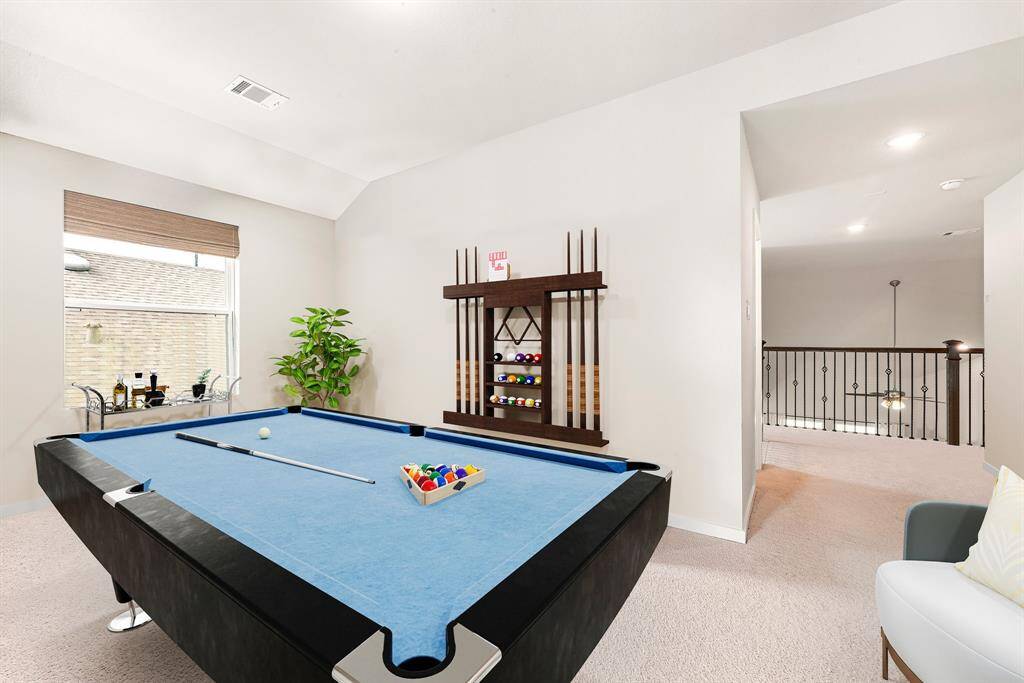 Come upstairs and enjoy a day of leisure in this fabulous game room/media room! This is the perfect hangout spot or adult game room, this space features plush carpet, high vaulted ceiling, recessed lighting, custom paint and storage closet. *Virtually Staged