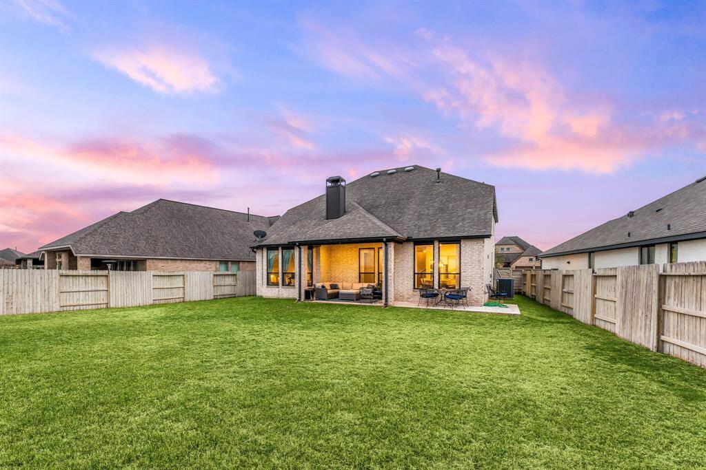Experience seamless indoor-outdoor living in this spacious yard featuring a cozy covered patio—ideal for entertaining or relaxing.