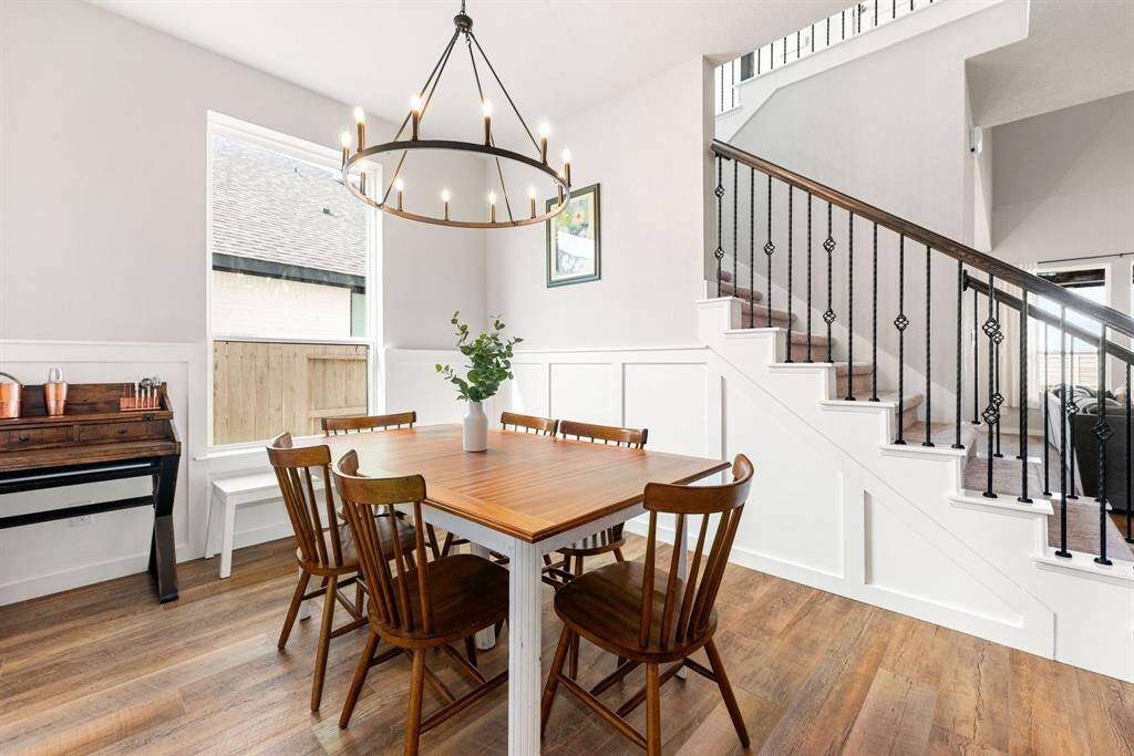 You and your guests will certainly dine in style in this amazing formal dining room! Featuring a gorgeous modern chandelier, large window, neutral paint, high ceilings, wood style tile flooring. Perfect space to entertain family and friends.