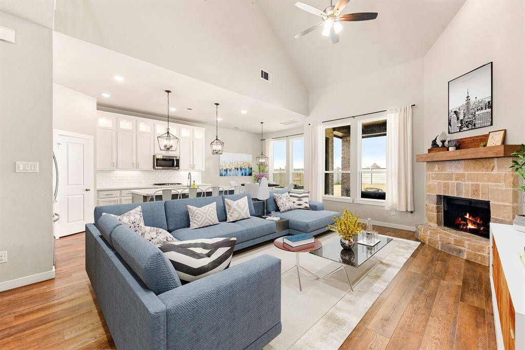 Gather the family and guests together in your lovely living room! Featuring soaring high ceilings, dark stained ceiling fan, custom paint, gorgeous wood style floors and large windows that provide plenty of natural lighting throughout the day. *Virtually Staged
