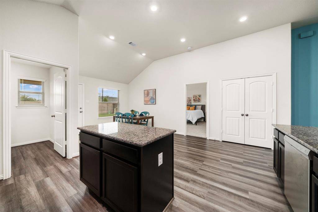 Central kitchen island offers another space for prep or serving. Double doors ahead open to your pantry, the doorway to the left is to your laundry room.