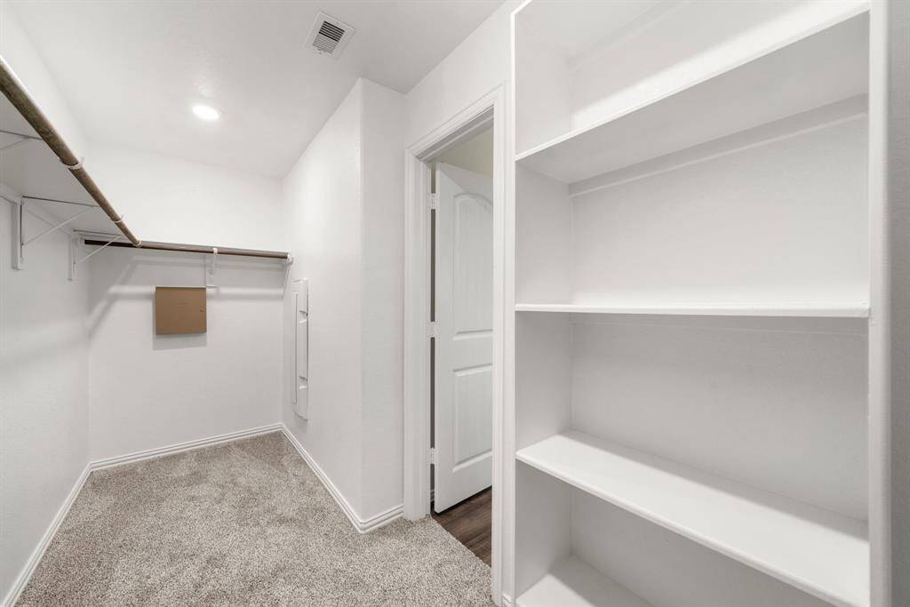 This image gives you a glimpse at the large walk-in closet. Plenty of space for both hanging and shelf items.
