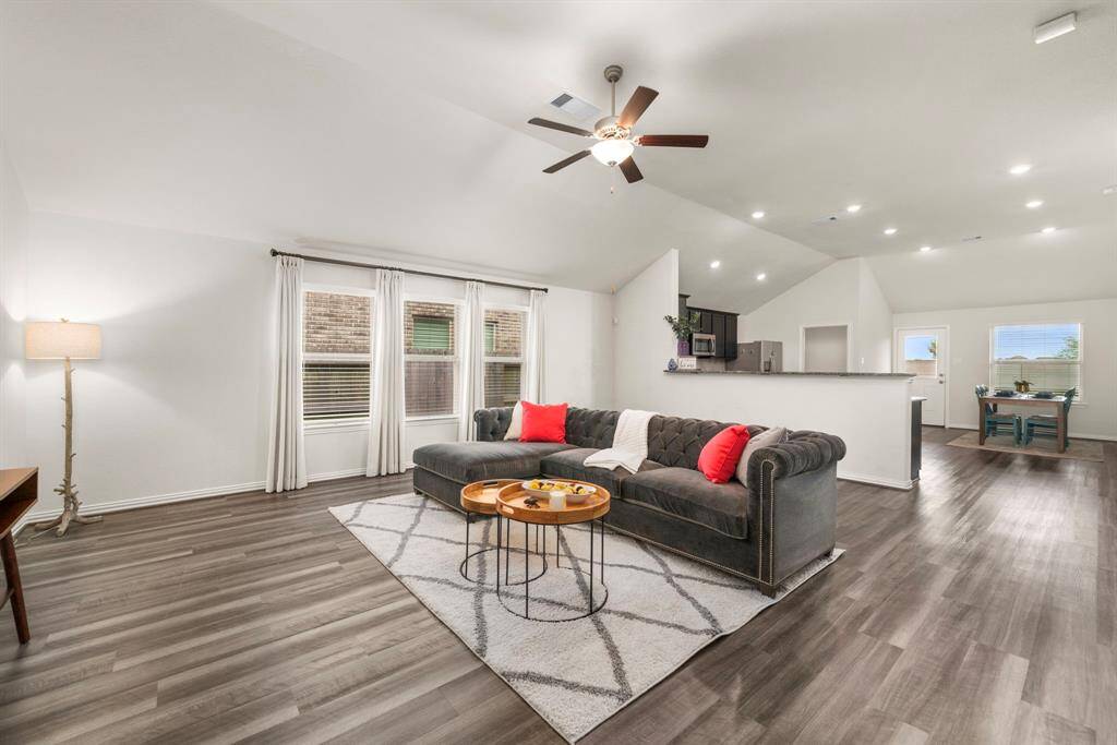 View of living from the entry hallway, looking towards the kitchen and dining area. Notice the large and expansive space that welcomes oversized furniture without eating up the entire space.