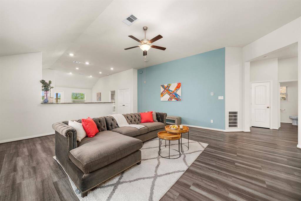 Alternate view of living looking towards kitchen/dining to the left, and secondary bedrooms/bathroom to the right.