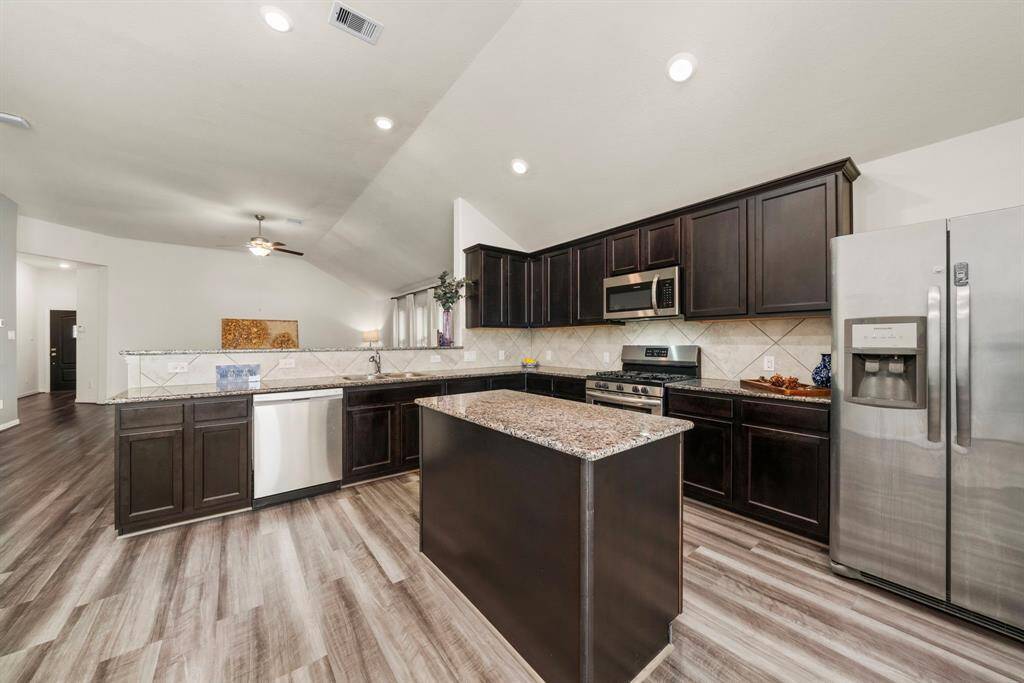 The timeless color palette continues into the kitchen. Notice the taller ceilings typically not seen in new construction of this price point!