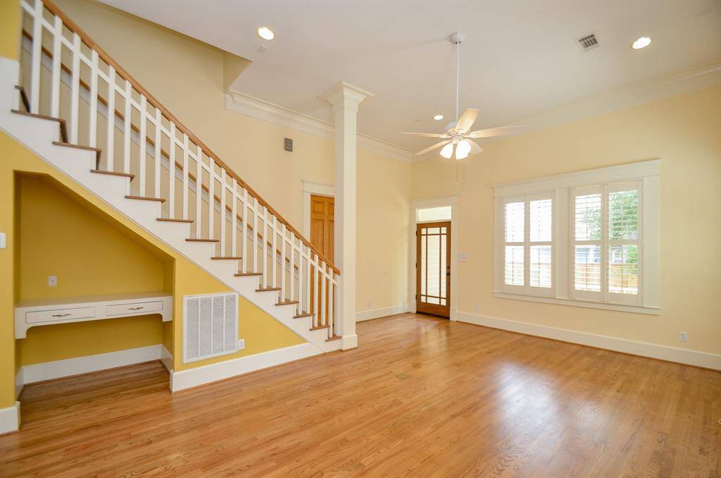Open den area with door to back porch.